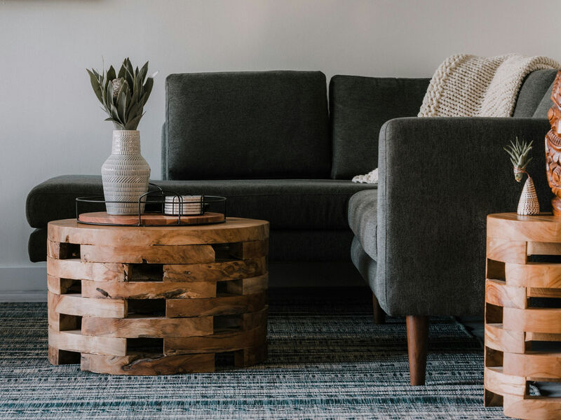 Stock image of a couch and coffee table with vase.