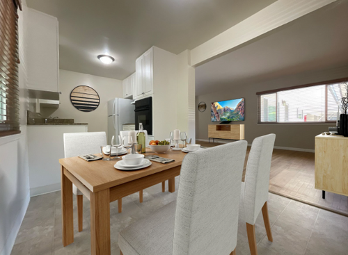 Kitchen view with white chairs around a wooden dining table