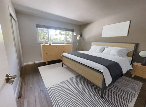Sunlight streaming into a furnished bedroom with a large bed against the wall opposite the doorway