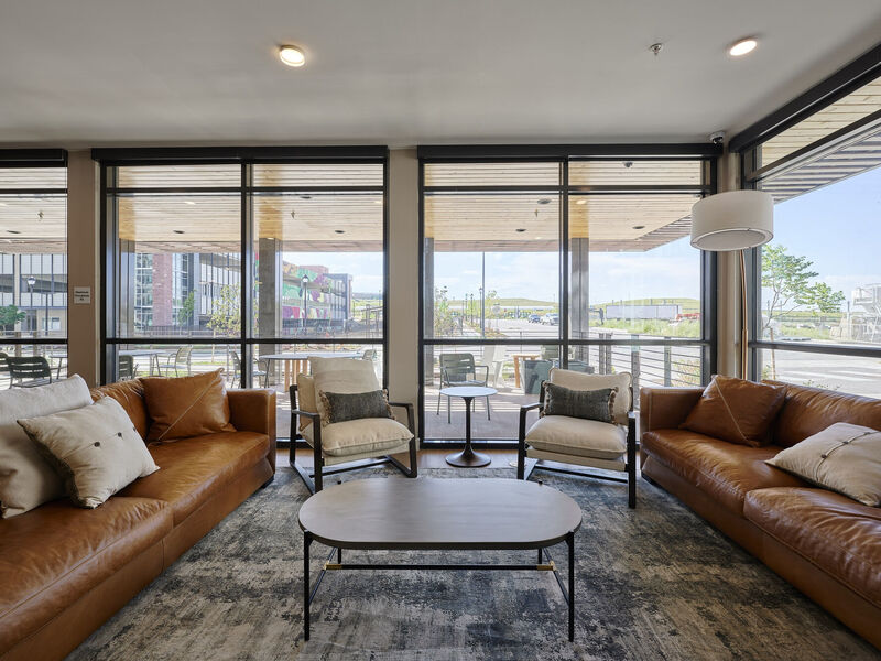 Clubhouse with large windows and sitting area with couches and chairs