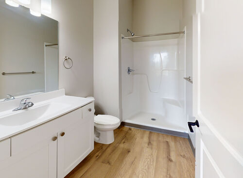 Bathroom with walk-in shower in loft apartment at Lofts at 128 located in downtown Hastings, MI