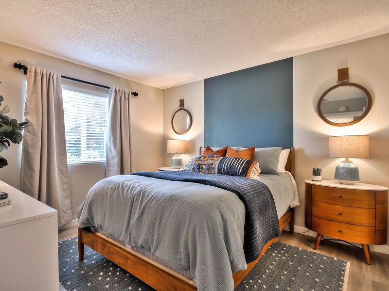 Bedroom furnished with bed, end table, and dresser.