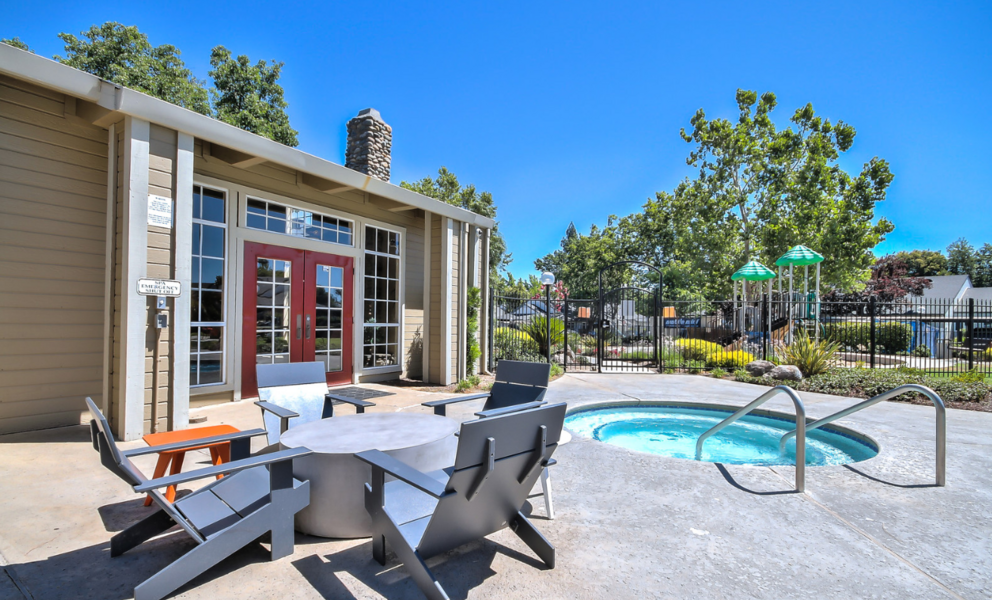 Exterior image of pool area spa and outdoor seating.
