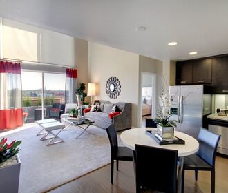 Spacious living room and kitchen with stainless steel appliances.