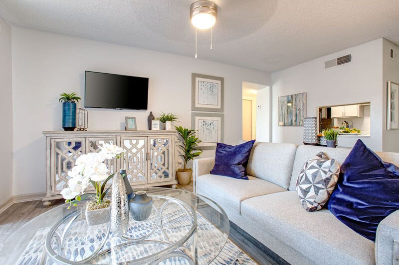 living room with taupe sofa and coffee table with vinyl wood like flooring at park alta