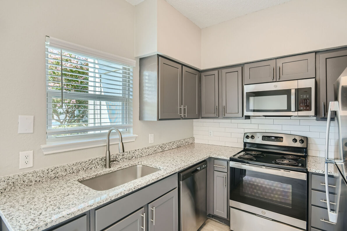 The Tallows Apartments renovated kitchen window view - Carrollton, TX
