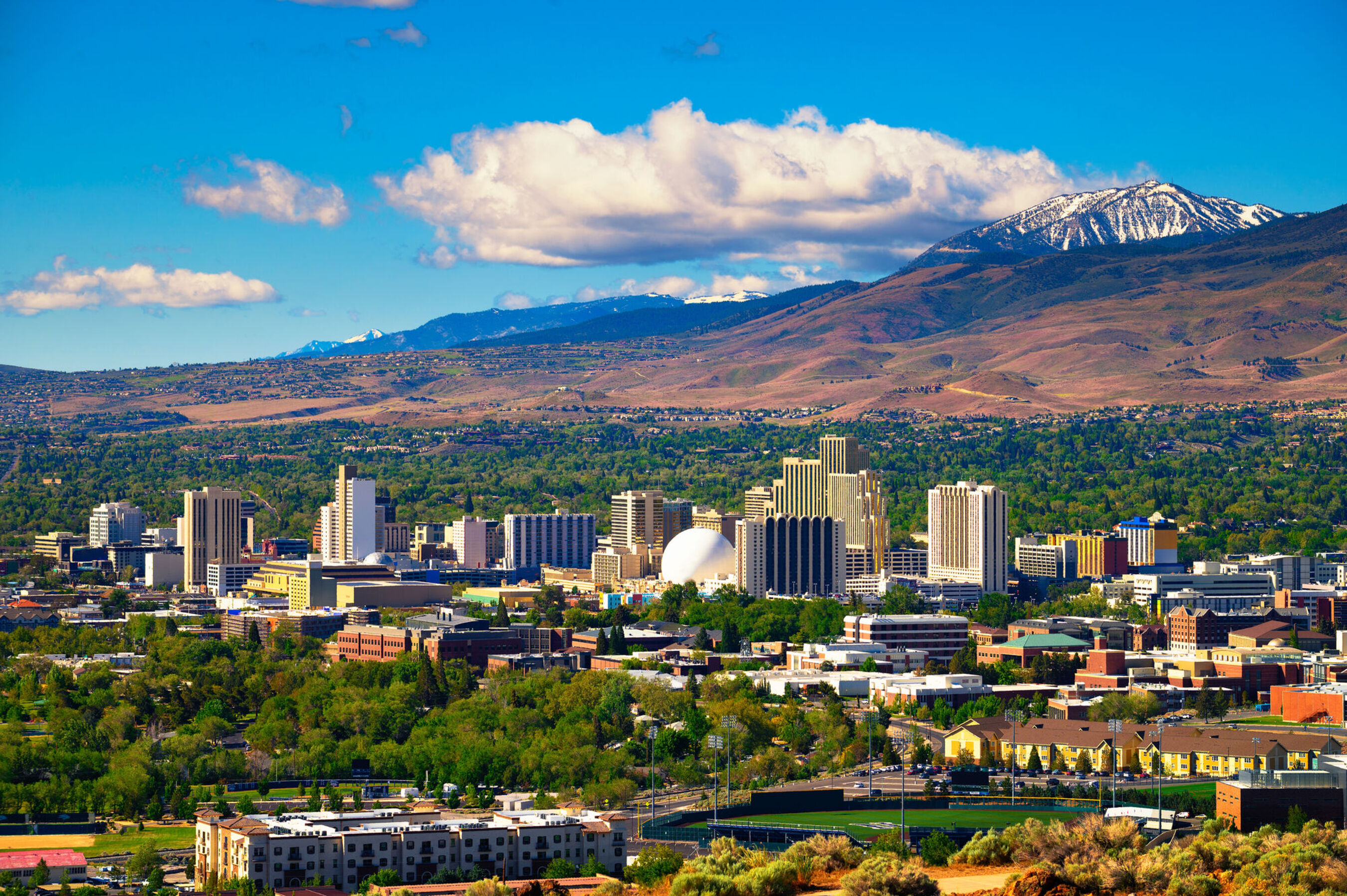 An aerial stock image of Reno, NV with mountains in the background