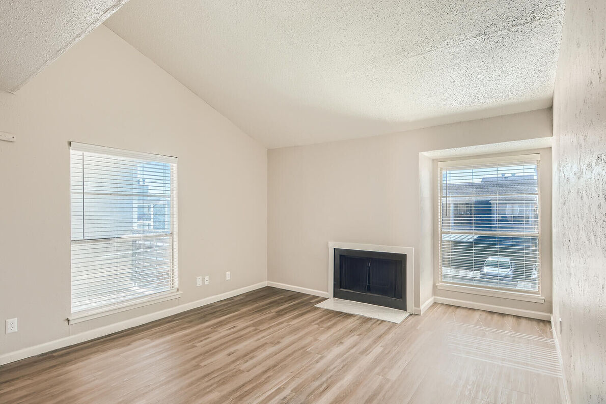 The Leighton Apartments renovated living room with fireplace - Plano, TX