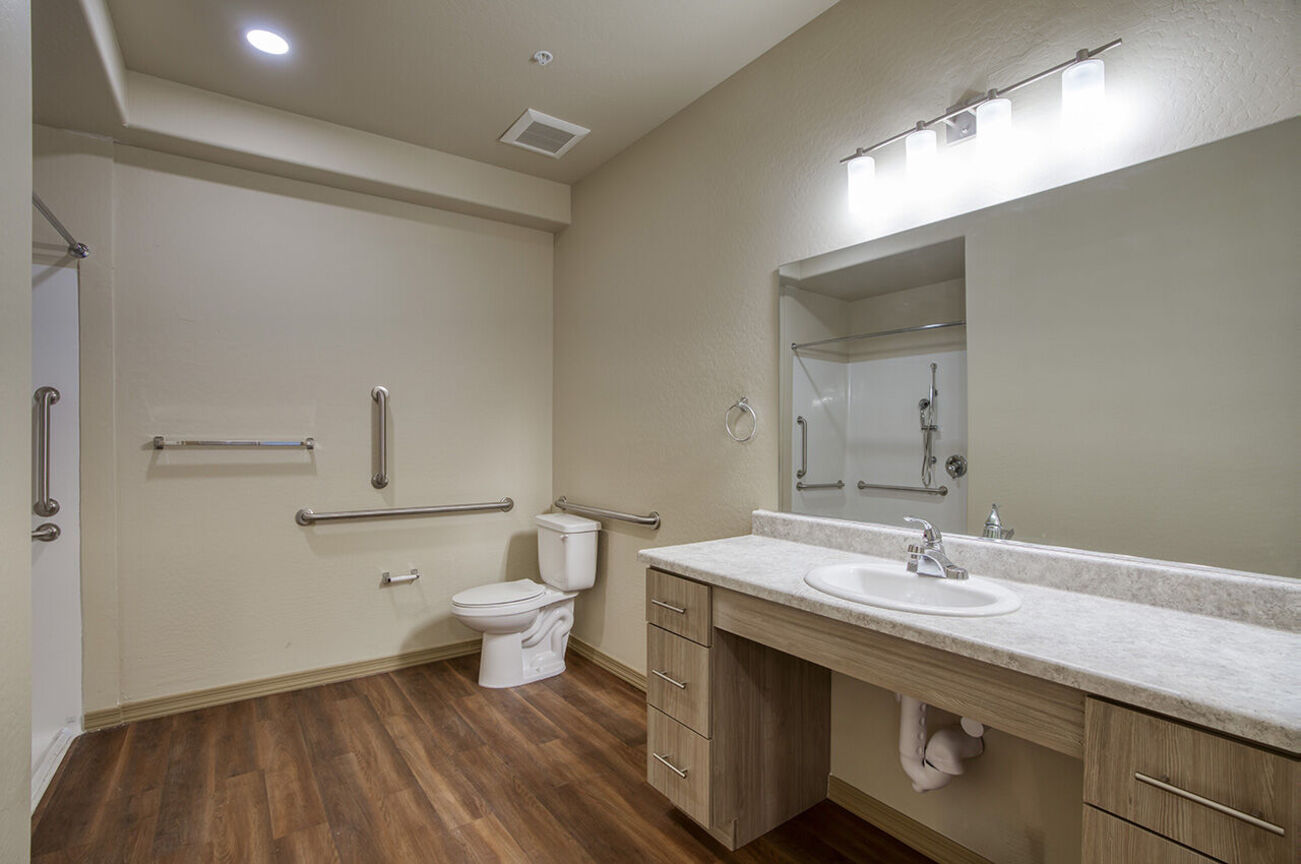 Bathroom with grab bars in the home shown at Harmony at the Park I & II.