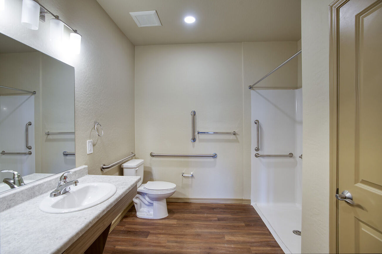 Bathroom with grab bars in the home shown at Harmony at the Park I & II.
