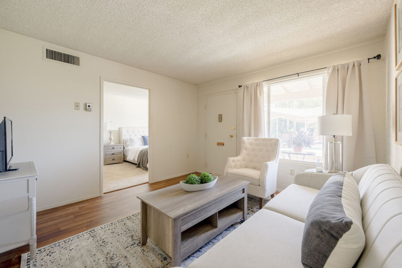 Furnished apartment living area shown at Phoenix Manor.