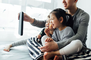 The image showcases a family using the Internet with ease, showcasing how simple it will be to use our Resident Portal.