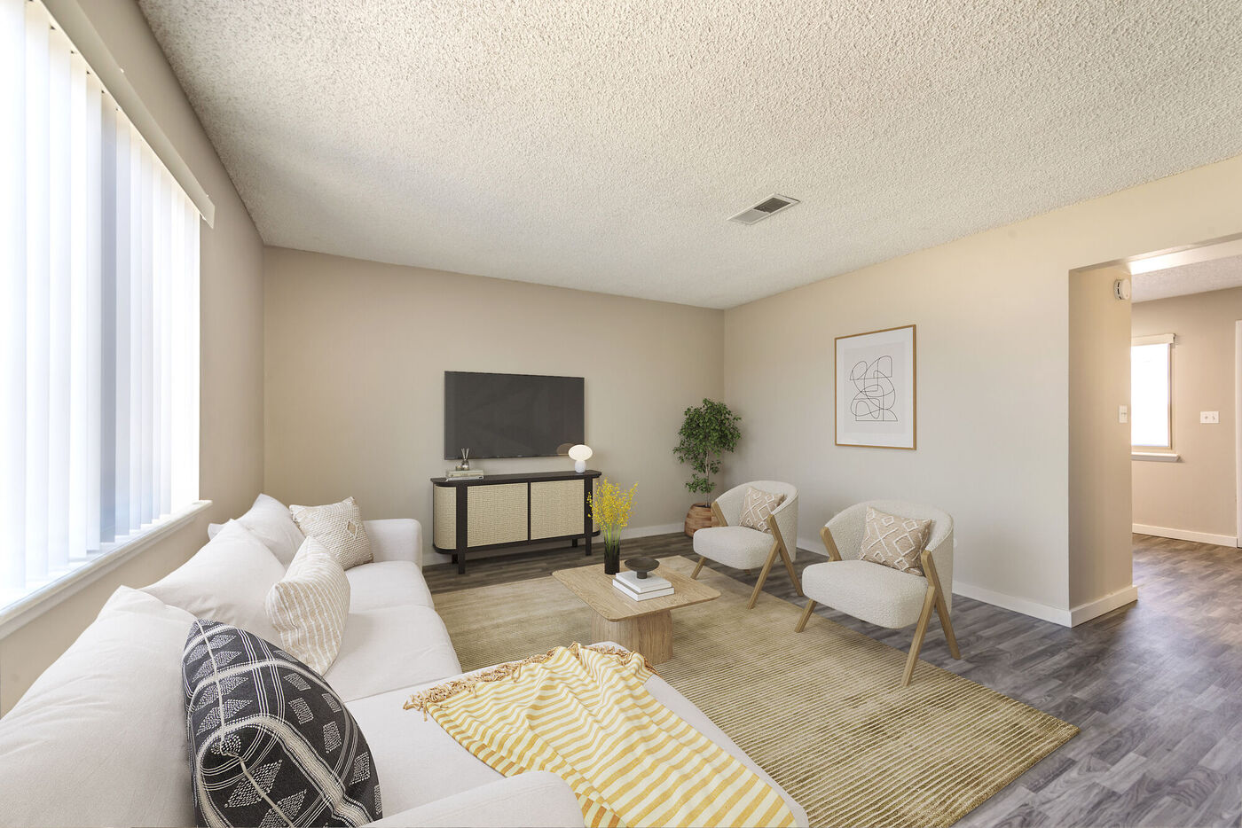 Living room and entry with luxury vinyl plank flooring, coat closet, and staircase.