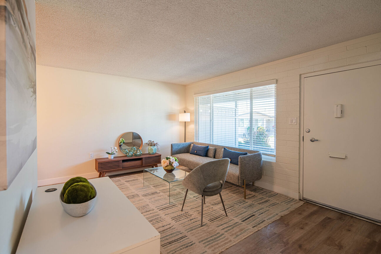 Furnished apartment living area shown at Phoenix Manor.