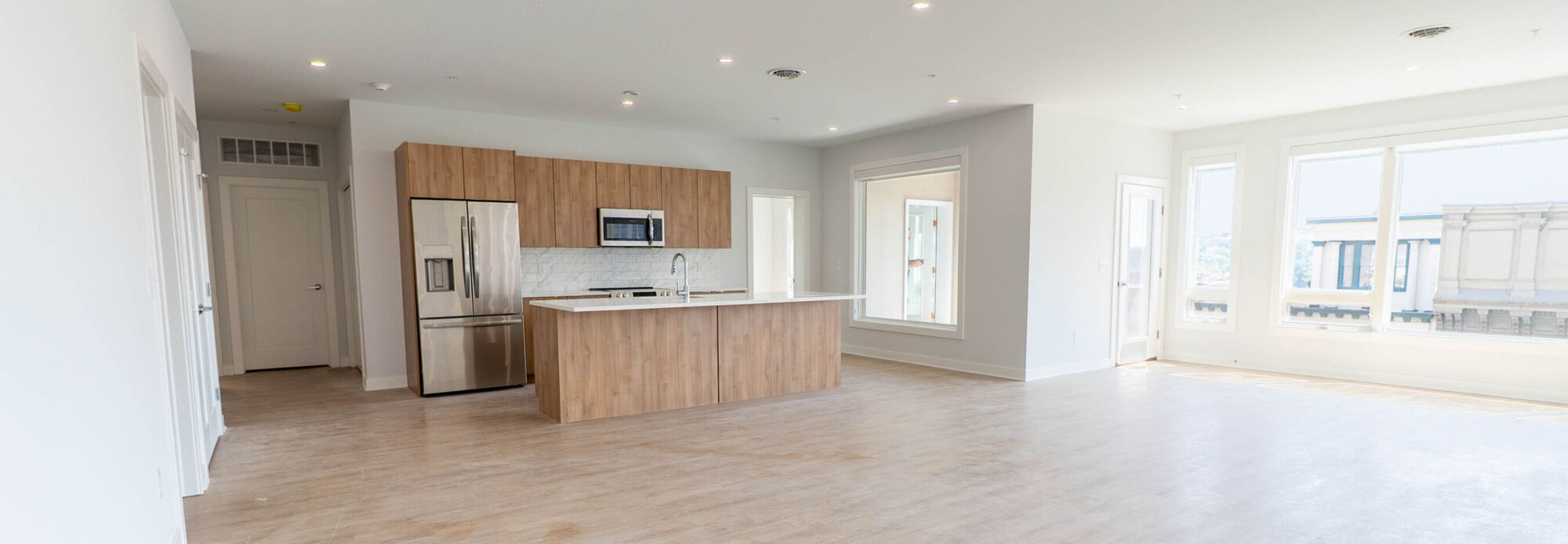 Spacious open-concept living room with natural light and modern furnishings at The Rise | Downtown