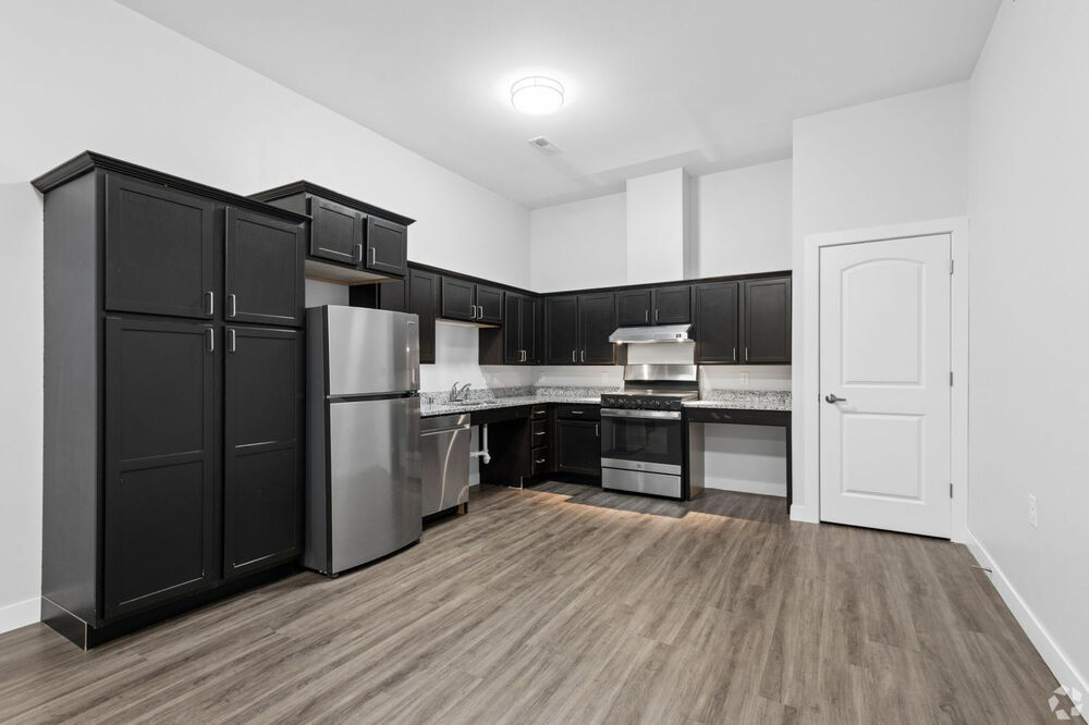 Picture of the kitchen sink, dishwasher, and beautiful cabinets in the Alice Place Senior Living Apartments in Monroe, WI.