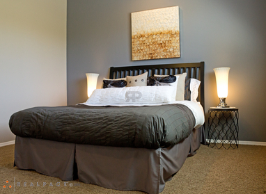Furnished bedroom shown — representative home at Camino Tomas.