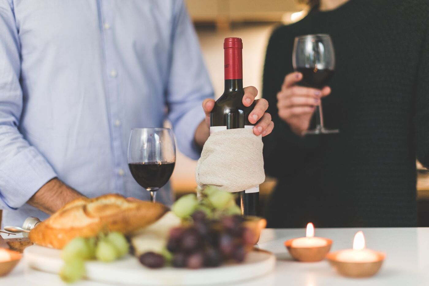 Audubon Village - Lifestyle filler image of two individuals sharing a bottle of wine.