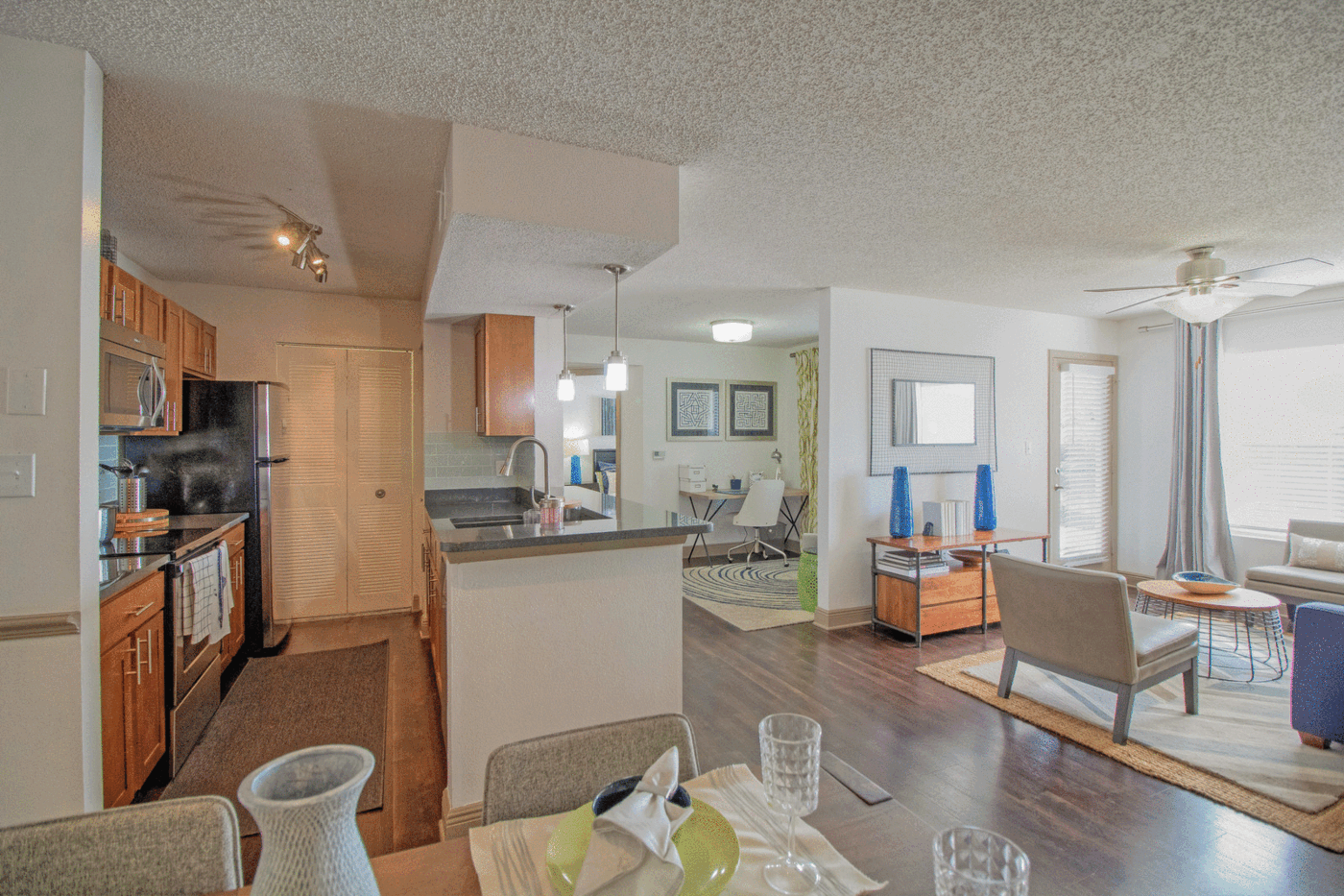 Audubon Village – Model apartment with a view of the kitchen, dining area, and living area.