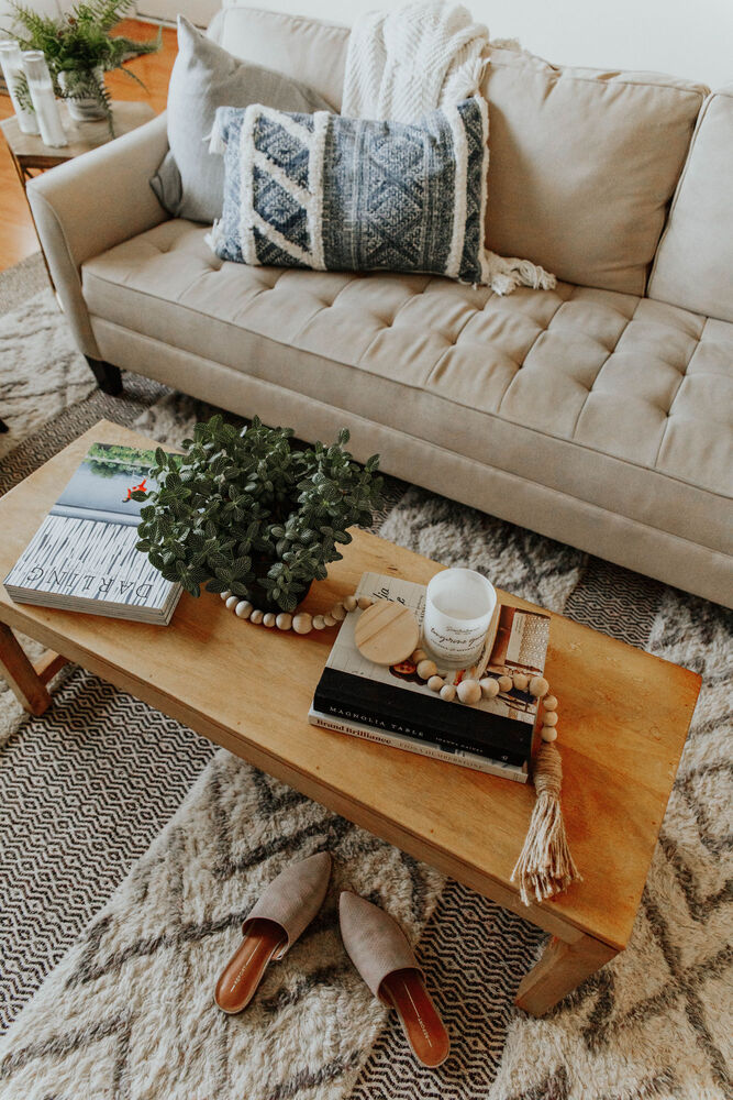 top view of coffee table and beige sofa with decorative pillows